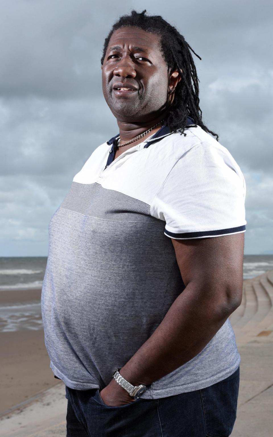 Scam victim Dexter Jeffrey stands by the beach while on holiday in Blackpool - Credit: Asadour Guzelian