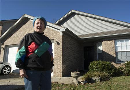 Ingrid Boak poses in front of her now-rented home in Lexington, Kentucky December 27, 2013. REUTERS/Tim Webb