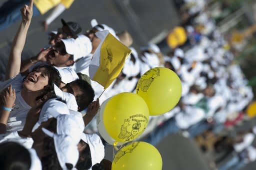 Youngsters wait for the arrival of Pope Benedict XVI along Lopez Mateos Boulevard in the City of Guanajuato, Mexico