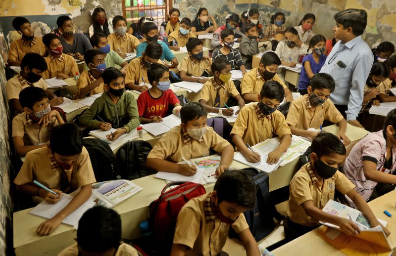 Schoolchildren attend class after the majority of schools were reopened following their closure due to the coronavirus disease (COVID-19) pandemic, in Mumbai