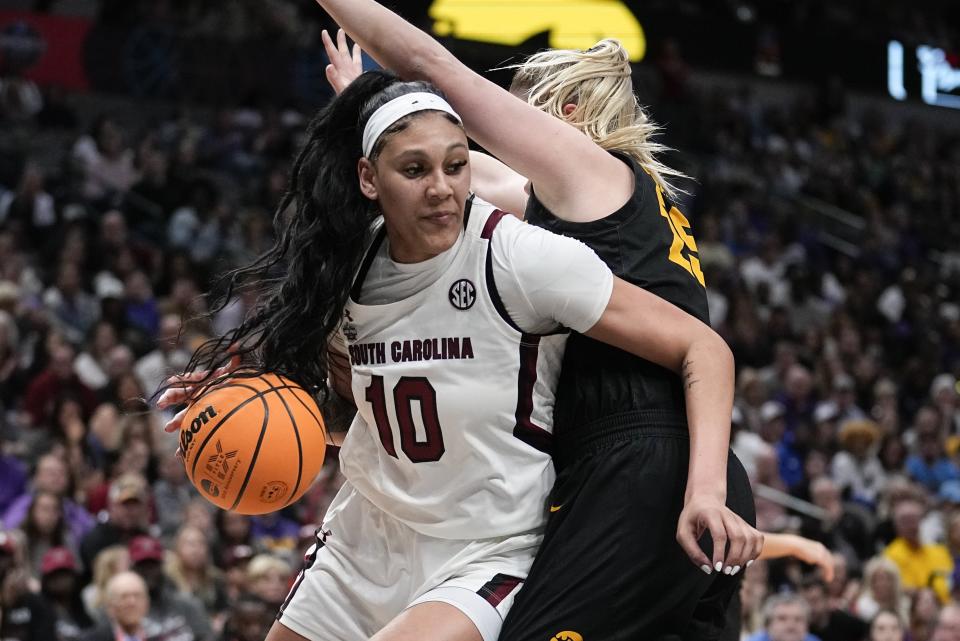 South Carolina's Kamilla Cardoso tries to get past Iowa's Monika Czinano during the first half of an NCAA Women's Final Four semifinals basketball game Friday, March 31, 2023, in Dallas. (AP Photo/Tony Gutierrez)