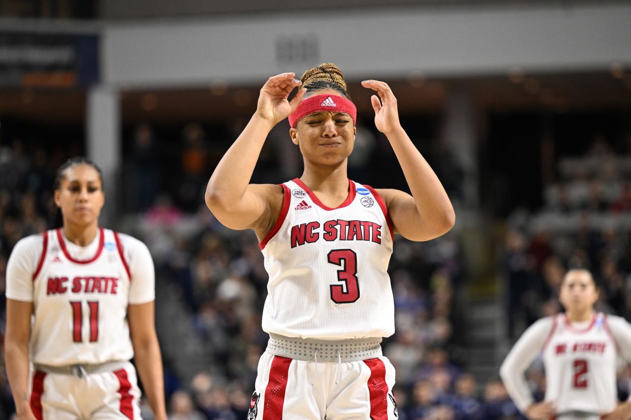 NC State players Kai Crutchfield, Jakia Brown-Turner (left), and Raina Perez (right) as they take on the UConn Huskies in their Elite Eight matchup hosted in in Bridgeport, Connecticut.