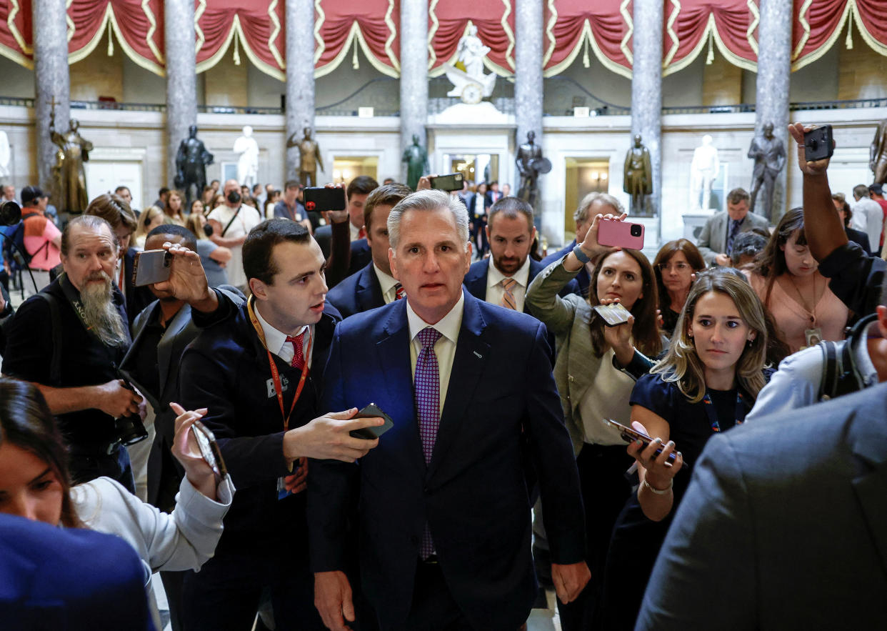 House Speaker Kevin McCarthy is surrounded by reporters inside the U.S. Capitol.