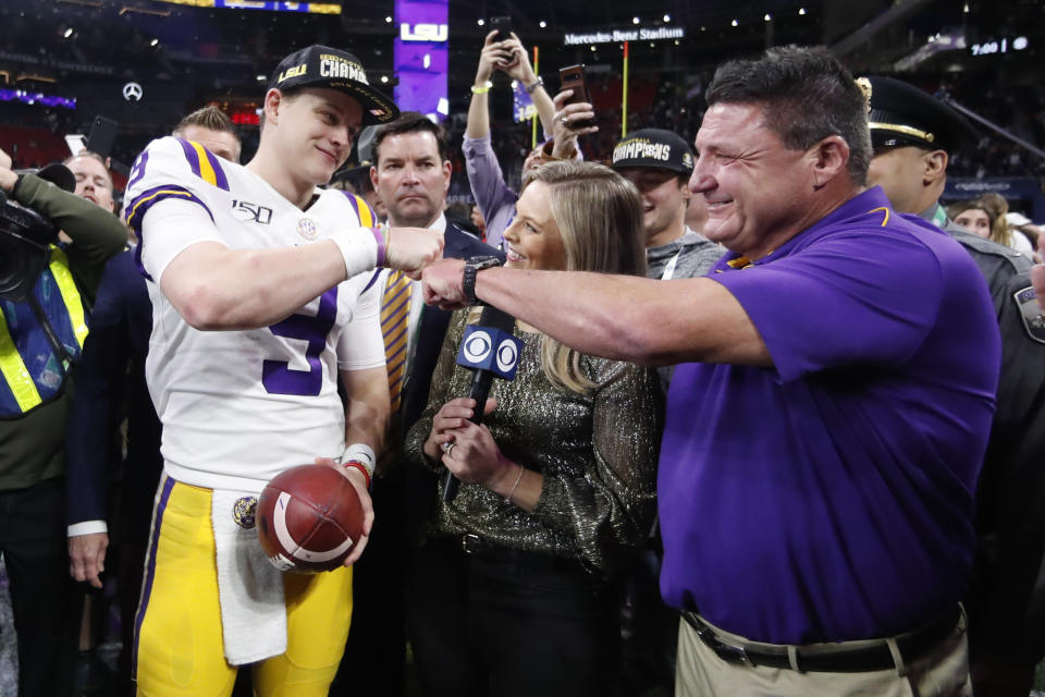 LSU quarterback Joe Burrow and LSU head coach Ed Orgeron celebrate after the Southeastern Conference championship NCAA college football game against Georgia, Saturday, Dec. 7, 2019, in Atlanta. LSU won 37-10. (AP Photo/John Bazemore)