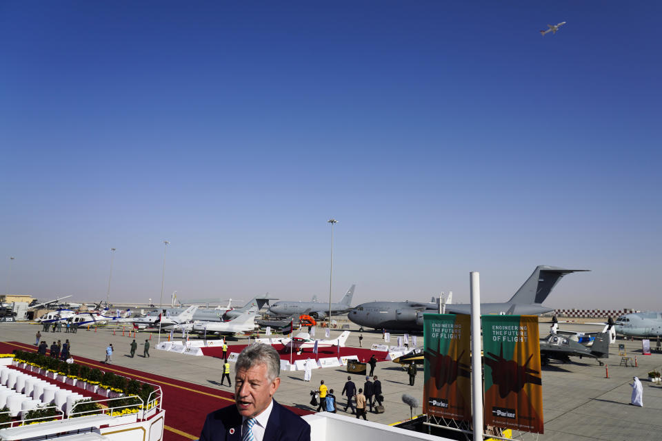 Paul Griffiths, the CEO of Dubai Airports, speaks to The Associated Press as a plane takes off behind him at the Dubai Air Show in Dubai, United Arab Emirates, Monday, Nov. 15, 2021. Dubai International Airport, the world's busiest airport for international travel, handled some 20% more passenger traffic in the third quarter of 2021 compared to the same period last year, Griffiths said Monday, signaling cautious optimism for the ravaged aviation industry even as a full recovery may remain years off. (AP Photo/Jon Gambrell)