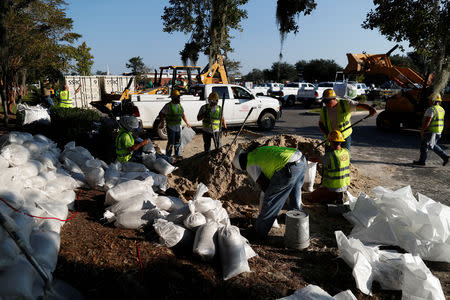 Workers place sand bags in anticipation of flood waters in the aftermath of Hurricane Florence now downgraded to a tropical depression in Conway, South Carolina, U.S., September 20, 2018. REUTERS/Randall Hill