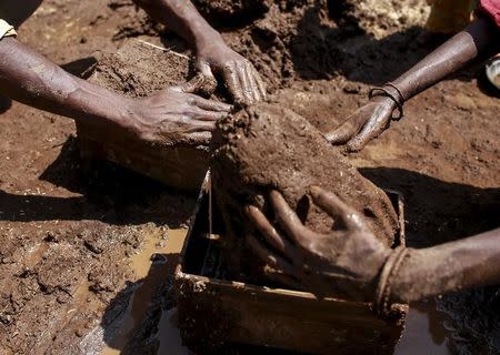 Labourers shape mud bricks as they work at a kiln in Karjat, India, March 10, 2016. REUTERS/Danish Siddiqui