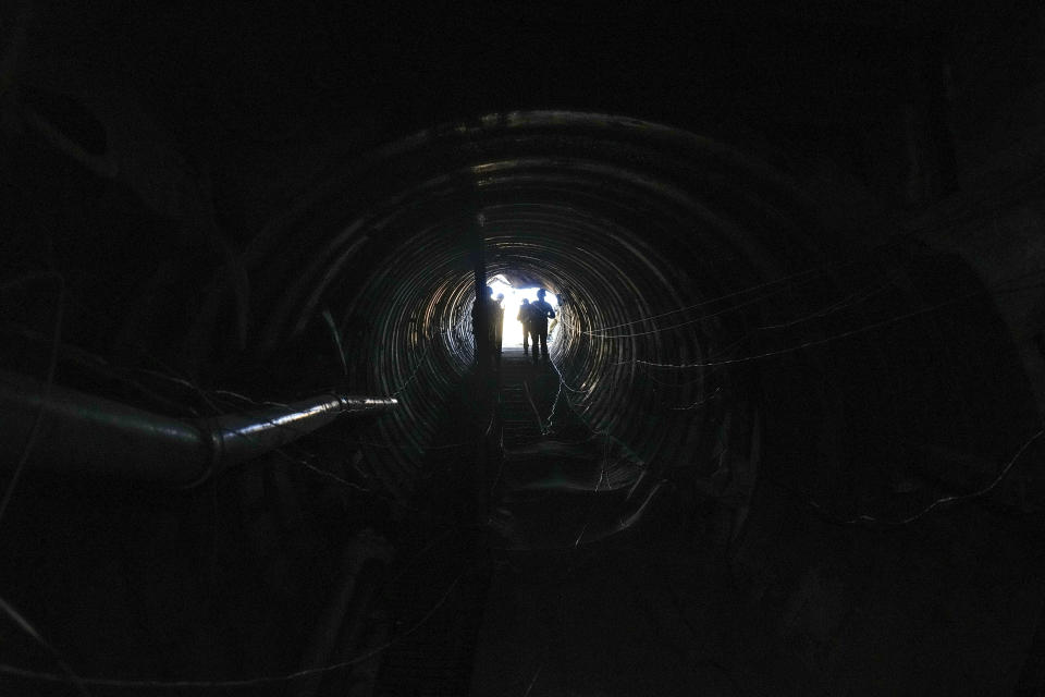 Israeli soldiers are seen in a tunnel that the military says Hamas militants used to attack the Erez crossing in the northern Gaza Strip, Friday, Dec. 15, 2023. The army is battling Palestinian militants across Gaza to retaliate for Hamas' Oct. 7 attack on Israel. (AP Photo/Ariel Schalit)