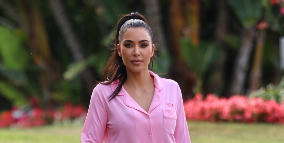 Kim Kardashian wearing skims pink pajamas click to shop