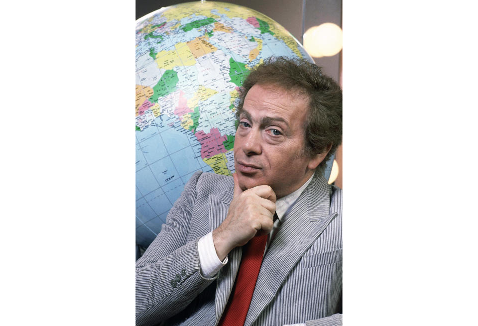 FILE - In this Jan. 27, 1987, file photo, Jackie Mason poses in his dressing with a globe as he stars in his own Broadway show in New York. Mason, a rabbi-turned-jokester whose feisty brand of standup comedy got laughs from nightclubs in the Catskills to West Coast talk shows and Broadway stages, has died. He was 93. Mason died Saturday, July 24, 2021, in Manhattan, the celebrity lawyer Raoul Felder told The Associated Press. (AP Photo/Carlos Rene Perez, File)