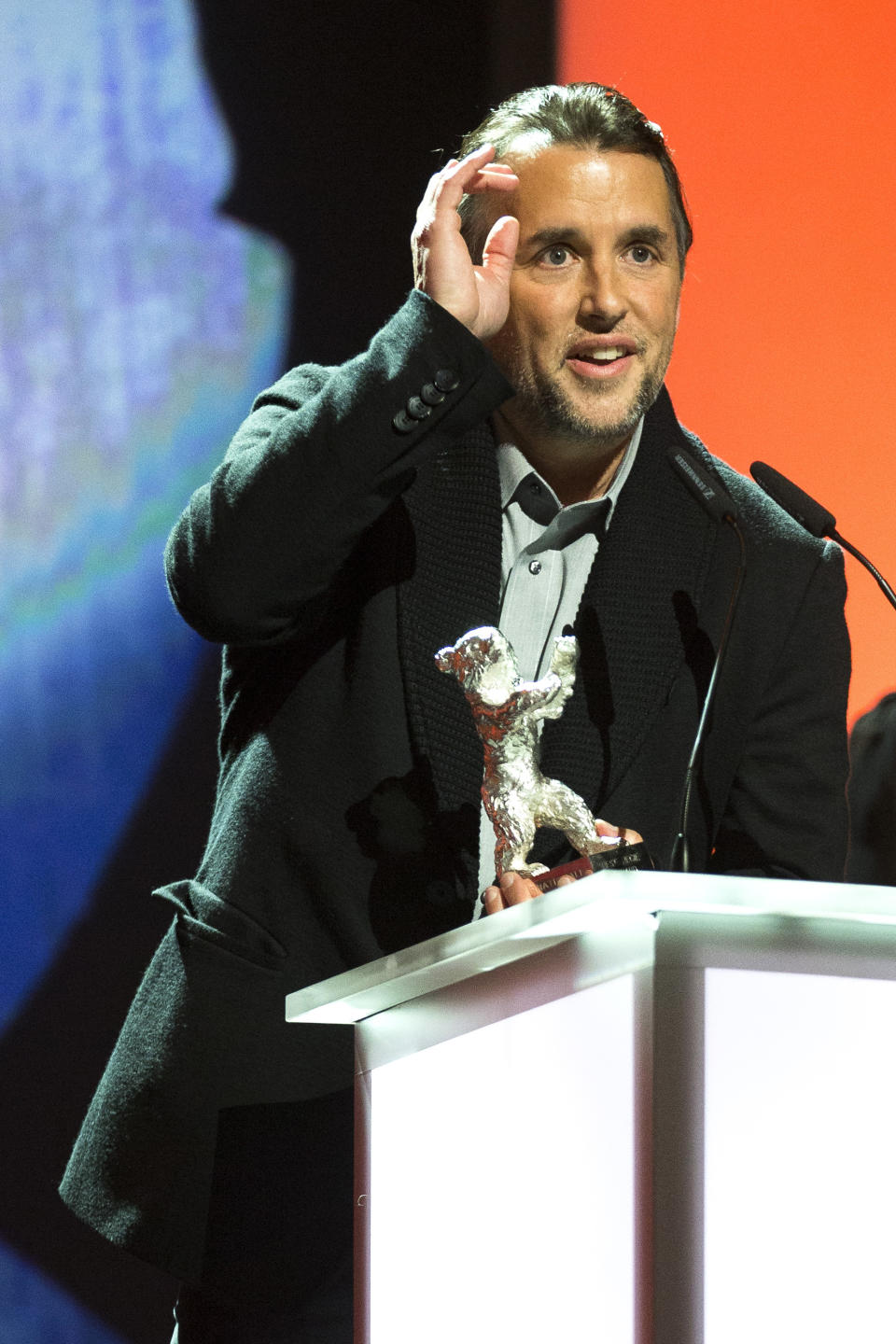 Richard Linklater receives the Silver Bear for Best Director for the movie Boyhood during the award ceremony at the International Film Festival Berlinale in Berlin, Saturday, Jan. 15, 2014. (AP Photo/Axel Schmidt)