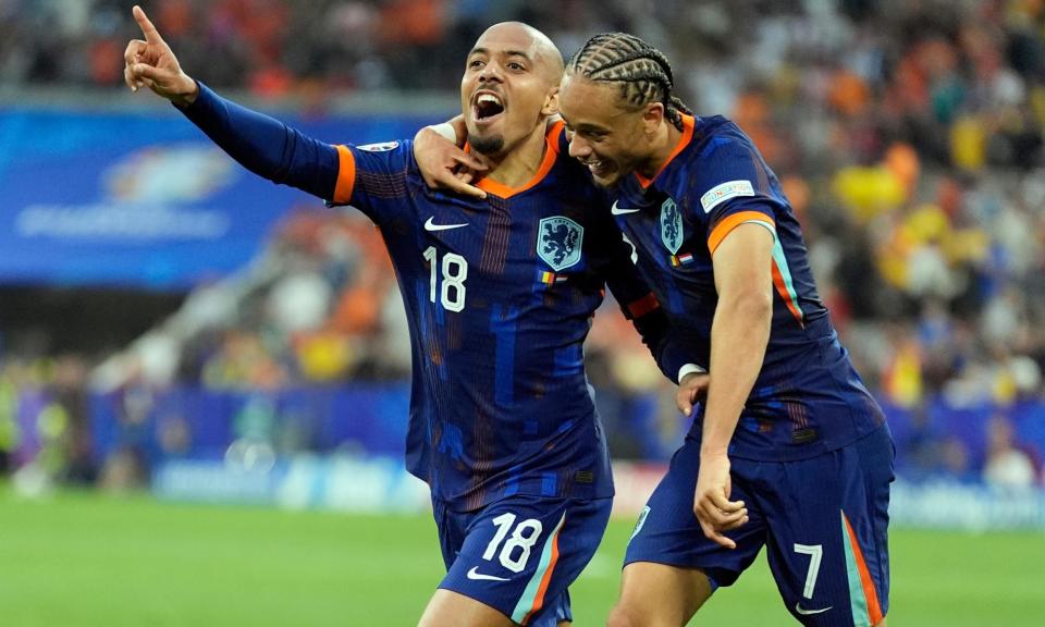 <span>Donyell Malen celebrates with Xavi Simons after scoring the third goal against Romania.</span><span>Photograph: Ariel Schalit/AP</span>