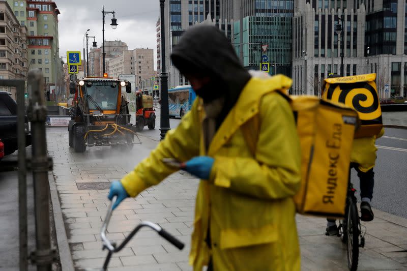 FILE PHOTO: Yandex.Eats food delivery couriers are seen in the street in Moscow