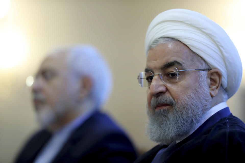 In this photo released by official website of the office of the Iranian Presidency, President Hassan Rouhani attends a meeting with a group of foreign ministry officials in Tehran, Iran, Sunday, July 22, 2018. Rouhani warned President Donald Trump against provoking his country while indicating peace between the two nations might still be possible. (Iranian Presidency Office via AP)