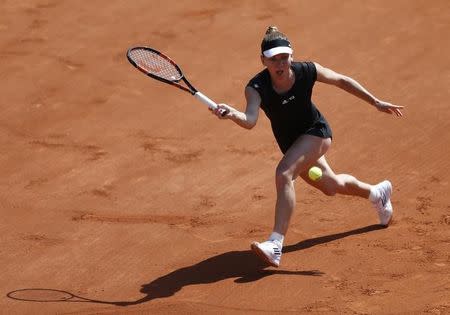 Simona Halep of Romania plays a shot to Evgeniya Rodina of Russia during their women's singles match at the French Open tennis tournament at the Roland Garros stadium in Paris, France, May 24, 2015. REUTERS/Vincent Kessler