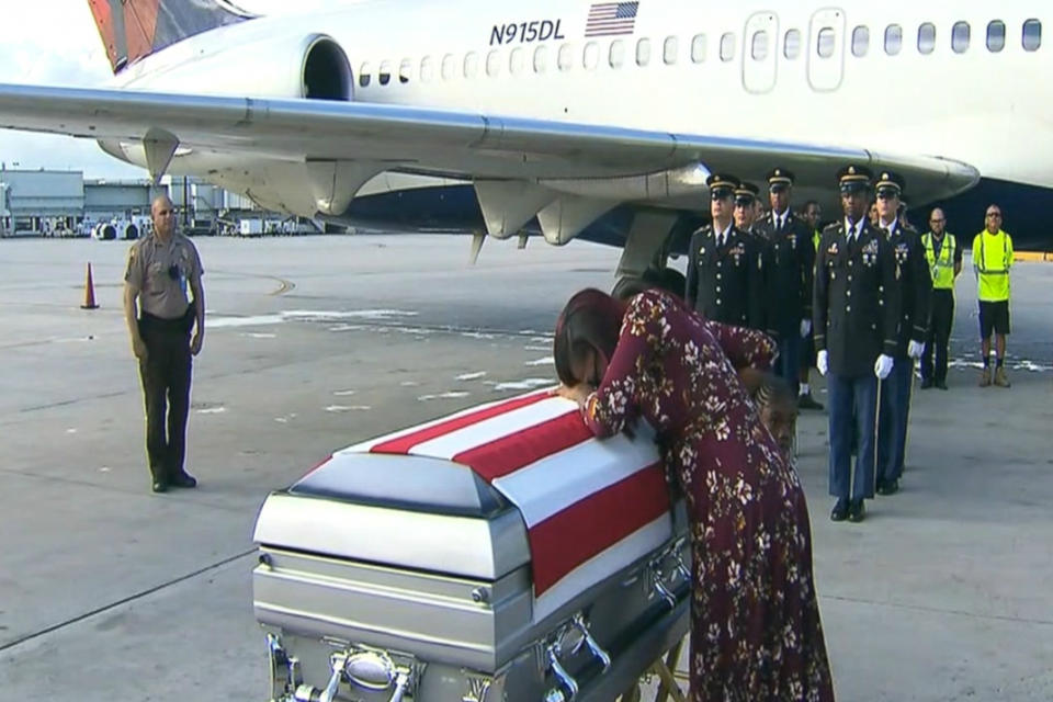 Myeshia Johnson collapses over the flag-draped casket of her husband, Army Sgt. La David Johnson, upon its arrival in Florida on Tuesday. (Screenshot: ABC Miami)