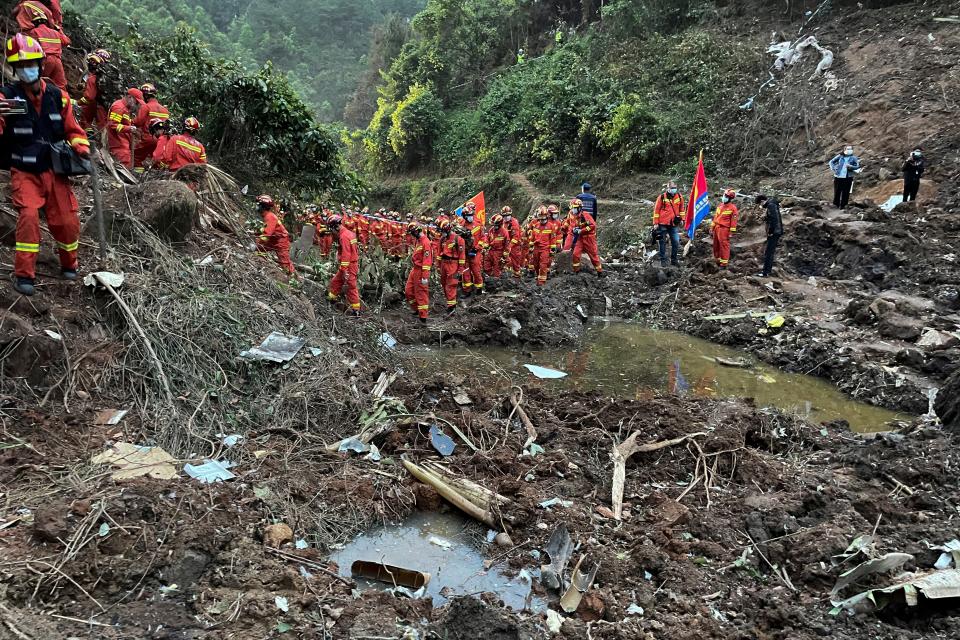 In this photo released by Xinhua News Agency, rescuers conduct search operations at the site of a plane crash in Tengxian County in southern China’s Guangxi region on Tuesday (AP)