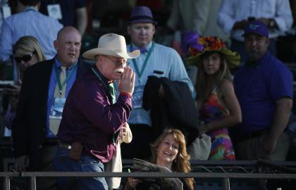 California Chrome co-owner Steve Coburn calls from the grandstand at Belmont Park. (AP Photo)
