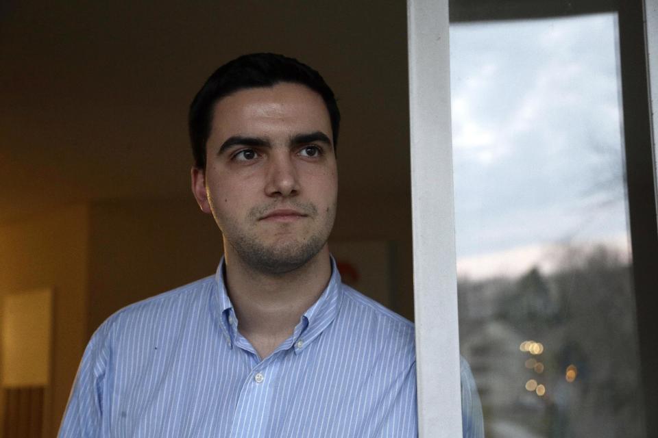 In this Thursday, Feb. 2, 2017 photo, John Cooper looks out of his home in Chapel Hill, N.C. Cooper says there is an urgent need for authorities to finally intervene in the Word of Faith Fellowship church in Spindale, N.C. "What’s going on now isn't right. What went on for my entire childhood wasn't right," he said. (AP Photo/Gerry Broome)