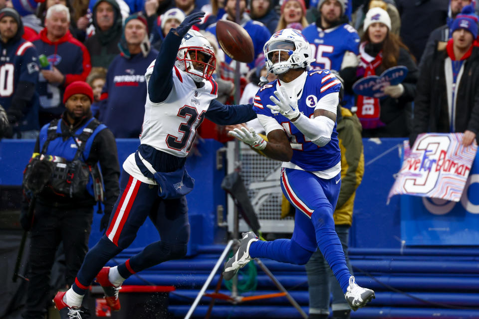Buffalo Bills wide receiver Stefon Diggs (14) catches a pass before running in for a touchdown against New England Patriots cornerback Jonathan Jones (31) during the second half of an NFL football game, Sunday, Jan. 8, 2023, in Orchard Park. (AP Photo/Jeffrey T. Barnes)