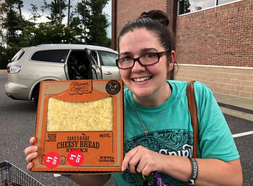 Self-proclaimed Aldi nerd Sandy Rigsby holds up cheesy bread sticks that she purchased at the discount supermarket chain in Chester.