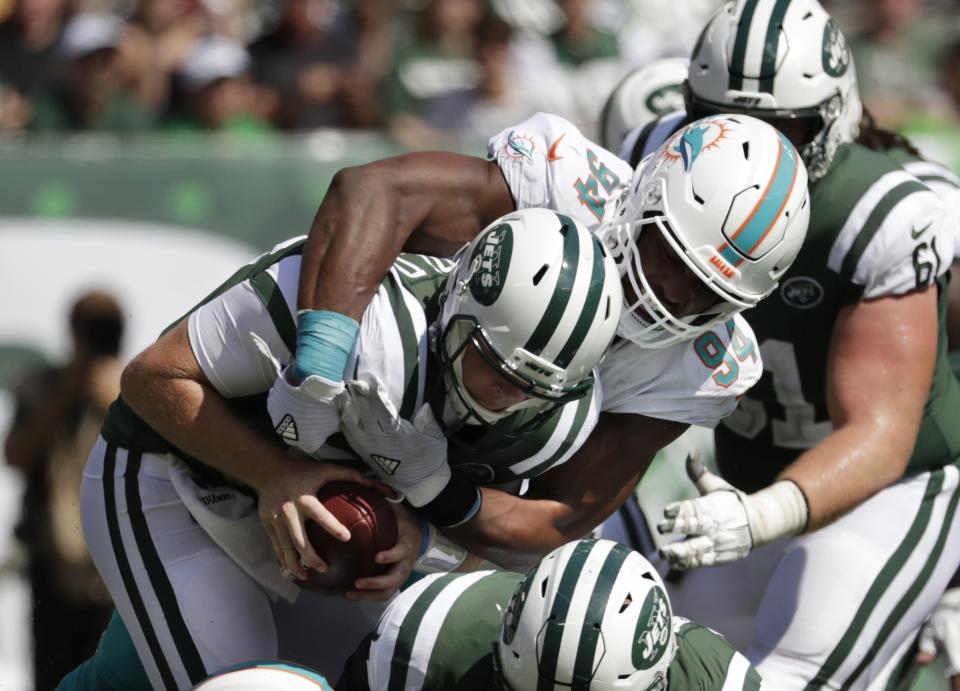 FILE - In this Sept. 16, 2018, file photo, Miami Dolphins' Robert Quinn (94) sacks New York Jets' Sam Darnold (14) during the first half of an NFL football game in East Rutherford, N.J. The Oakland Raiders play the Dolphins this week. "The addition of Quinn is huge," says Raiders coach Jon Gruden. "He has given them supreme effort opposite Cameron Wake. And they have a very good unit inside that can generate pressure as well. It's a combination of new players, new energy and the scheme. It's fun to watch them." (AP Photo/Julio Cortez, File)