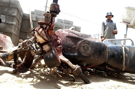 A Palestinian looks at the blood-stained motorcycle riden by 21-year-old Ghaleb Ermilat, when he was killed in an Israeli military strike in Rafah. The military wing of Hamas said late on Wednesday it had agreed to an Egyptian-brokered ceasefire with Israel, after three days of bloodshed in and around Gaza