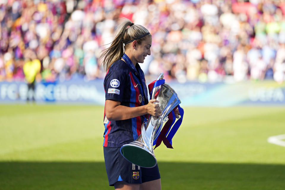 Barcelona's captain Alexia Putellas carries the trophy after winning the Women's Champions League final soccer match between FC Barcelona and VfL Wolfsburg at the PSV Stadion in Eindhoven, Netherlands, Saturday, June 3, 2023. Barcelona won 3-2. (AP Photo/Martin Meissner)