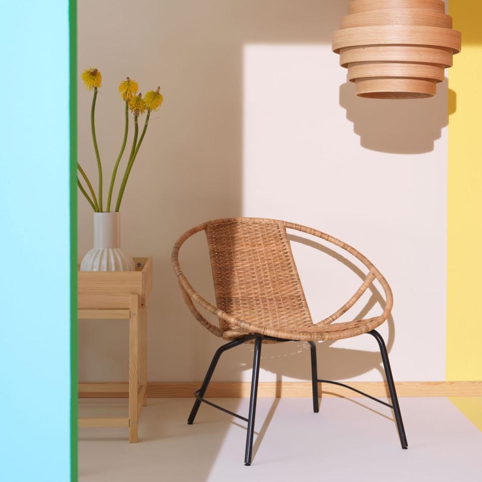 a chair with a vase of yellow flowers on top of it