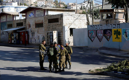 Israeli soldiers stand at a military camp in the West Bank city of Hebron October 17, 2017. REUTERS/Mussa Qawasma