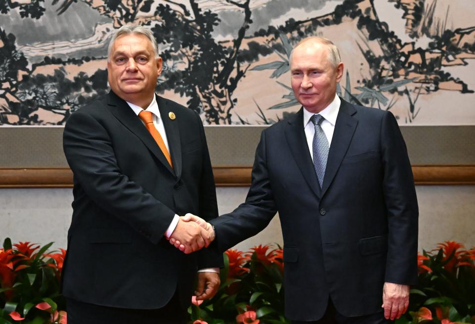 Hungary’s prime minister Viktor Orban shakes hands with Vladimir Putin in Beijing, in defiance of EU opposition to Russia over the invasion of Ukraine (EPA)