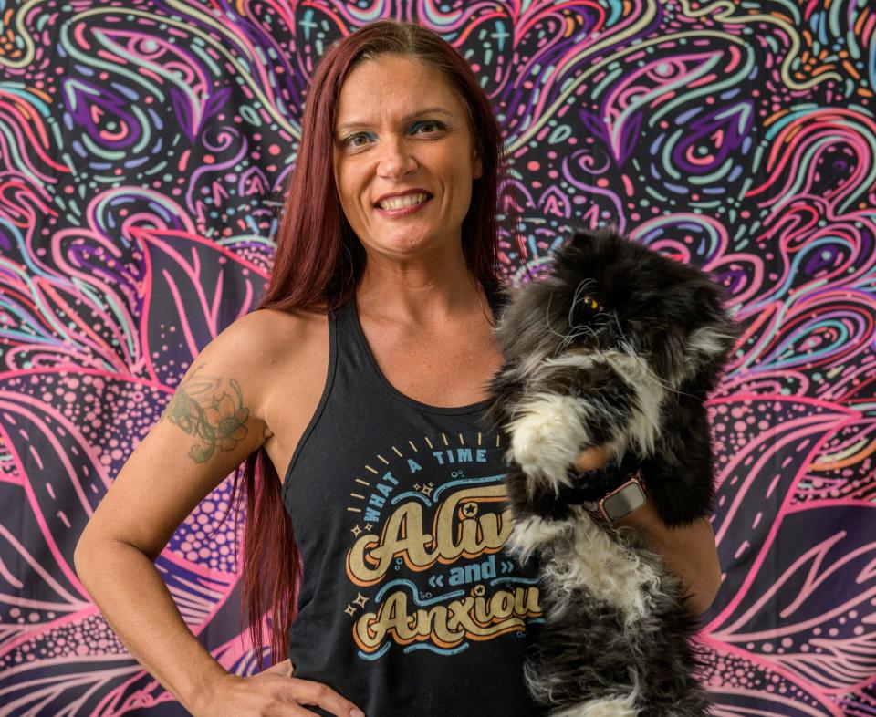 Tamra Antenucci stands with Athena, one of her cats, in their Peoria Heights home. Antenucci has encountered numerous difficulties trying to get mental health services for herself and her teenage son in the Peoria area.