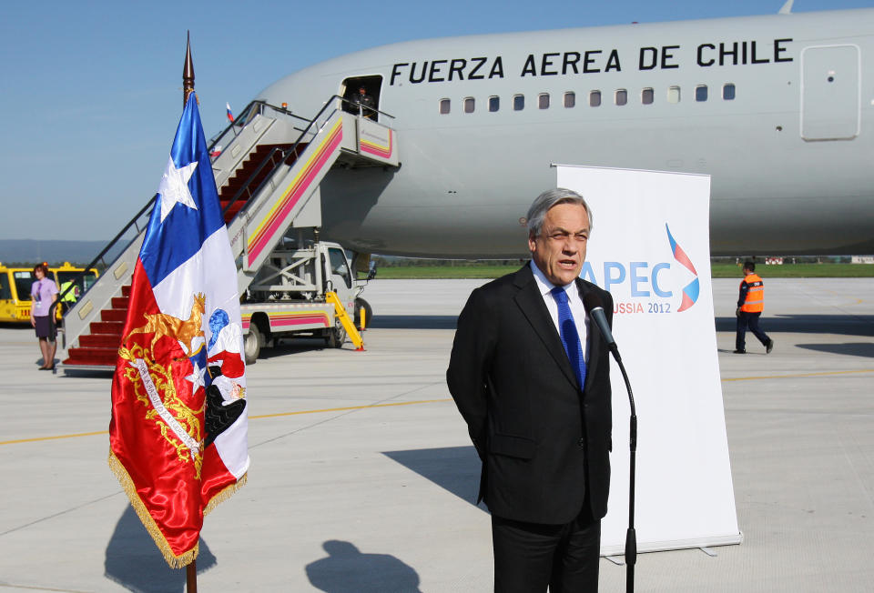 In this photo released by APEC 2012, Chilean President Sebastian Pinera delivers a speech on the tarmac after his arrival for the APEC summit in Vladivostok, Russia, Friday, Sept. 7, 2012, . (AP Photo/APEC2012)