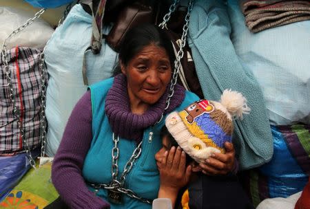 Yolanda Macarisantos holds her son David, as she chains herself outside of the health ministry to protest for what they describe as rampant pollution from a sprawling polymetallic mine operated by Peruvian mining company Volcan, in Lima, Peru June 22, 2017. REUTERS/Mariana Bazo