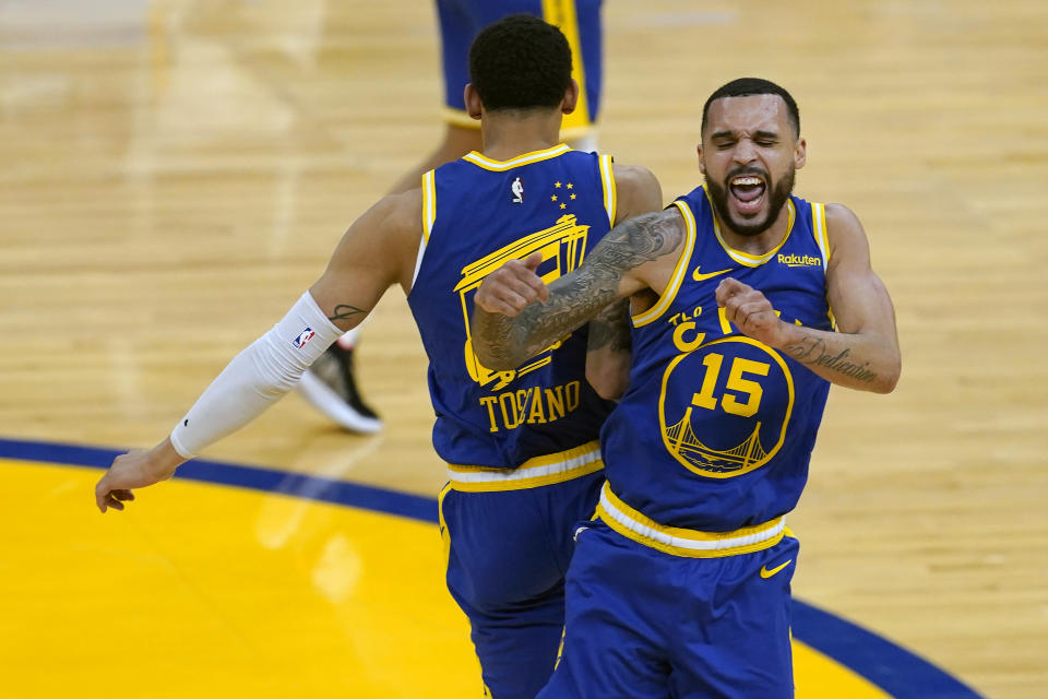 Golden State Warriors forward Juan Toscano-Anderson, left, celebrates with guard Mychal Mulder (15) during the second half of an NBA basketball game against the Utah Jazz in San Francisco, Monday, May 10, 2021. (AP Photo/Jeff Chiu)