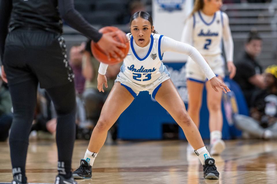 Lake Central high School junior Vanessa Wimberly (23) defends a Lawrence Central High School player during the first half of an IHSAA class 4A girls’ basketball state finals game, Saturday, Feb. 24, 2024, at Gainbridge Fieldhouse, in Indianapolis.