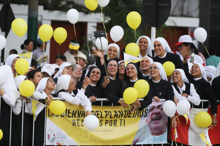 Nuns take a selfie while waiting for Pope Francis to drive past, in Lima, Peru January 18, 2018. REUTERS/Pilar Olivares