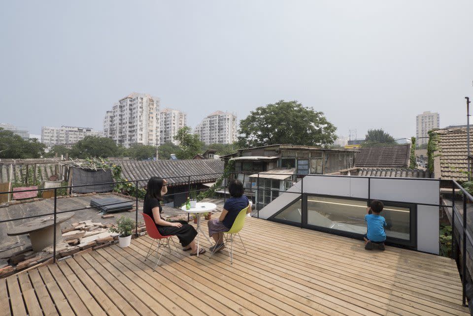 <p>Steps on the side of the house lead to a roof deck. </p>