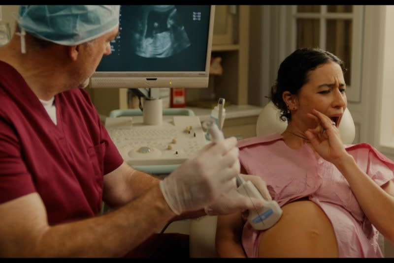 Eden (Ilana Glazer) has a checkup with her doctor (John Carroll Lynch). Photo courtesy of Neon