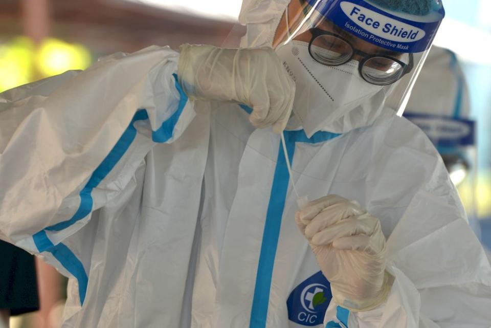 A health worker preparing to administer a Covid-19 test in Puchong, February 28,2021. — Picture by Miera Zulyana