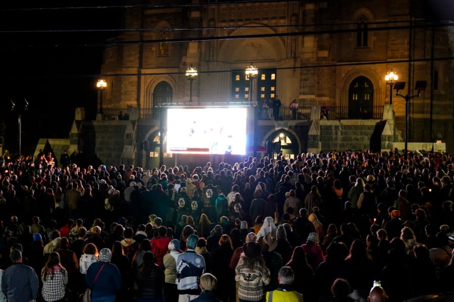 People gather at a vigil for the victims of Wednesday’s mass shootings, Sunday, Oct. 29, 2023, outside the Basilica of Saints Peter and Paul in Lewiston, Maine. (AP Photo/Matt Rourke)