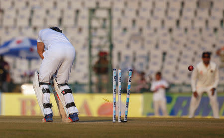 Cricket - India v England - Third Test cricket match - Punjab Cricket Association Stadium, Mohali, India - 26/11/16. England's Chris Woakes is bowled. REUTERS/Adnan Abidi