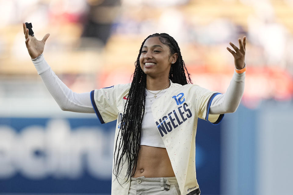 University of Southern California basketball player Juju Watkins gestures after throwing out the ceremonial first pitch prior to a baseball game between the Los Angeles Dodgers and the Los Angeles Angels Saturday, June 22, 2024, in Los Angeles. (AP Photo/Mark J. Terrill)