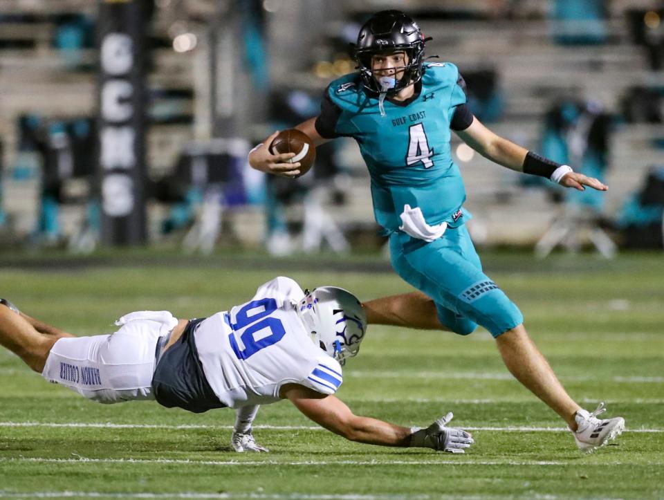 Gulf Coast Sharks quarterback Jace Seyler (4) evades a tackle from Barron Collier Cougars defensive lineman Erton Toska (99) during the third quarter of the Catfish Bowl at Gulf Coast High School in Naples on Friday, Nov. 3, 2023.