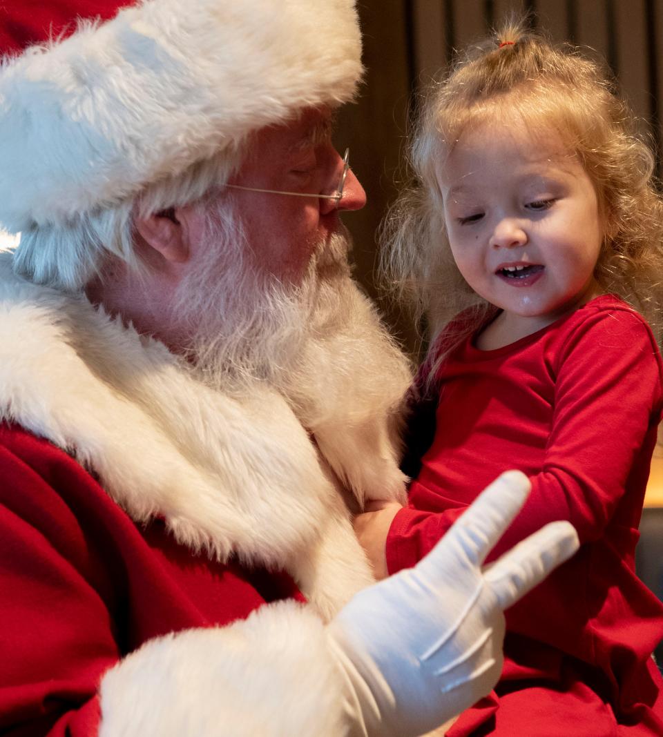 Randy Henshaw as Santa, holds Rorie Kloaky, 2, in the dining area at Harpeth Hotel in Franklin, Tenn., Saturday, Dec. 9, 2023.