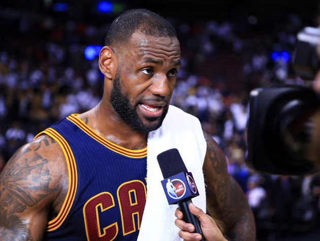LeBron James covers the spot that will one day advertise for tires. (Getty Images)