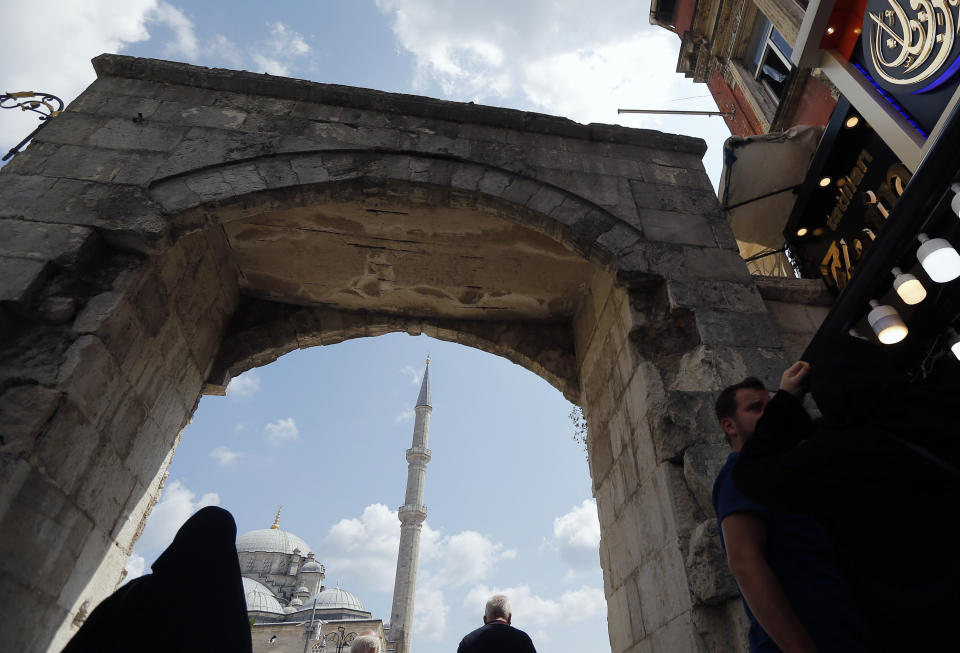 In this photo taken on Tuesday, Aug. 20, 2019, a man walks past Fatih mosque in Istanbul. Syrians say Turkey has been detaining and forcing some Syrian refugees to return back to their country the past month. The expulsions reflect increasing anti-refugee sentiment in Turkey, which opened its doors to millions of Syrians fleeing their country's civil war. (AP Photo/Lefteris Pitarakis)