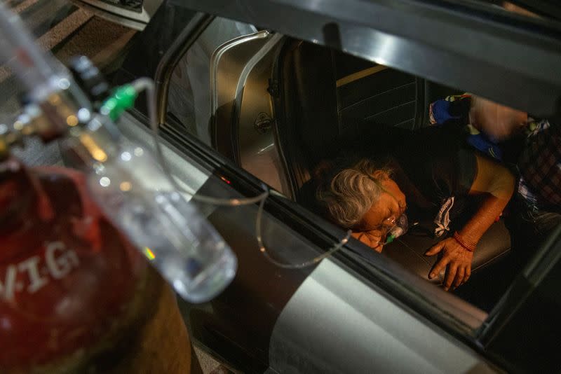 Vidhya Devi, who was suffering from a breathing problem receives oxygen support for free at a Gurudwara, in Ghaziabad