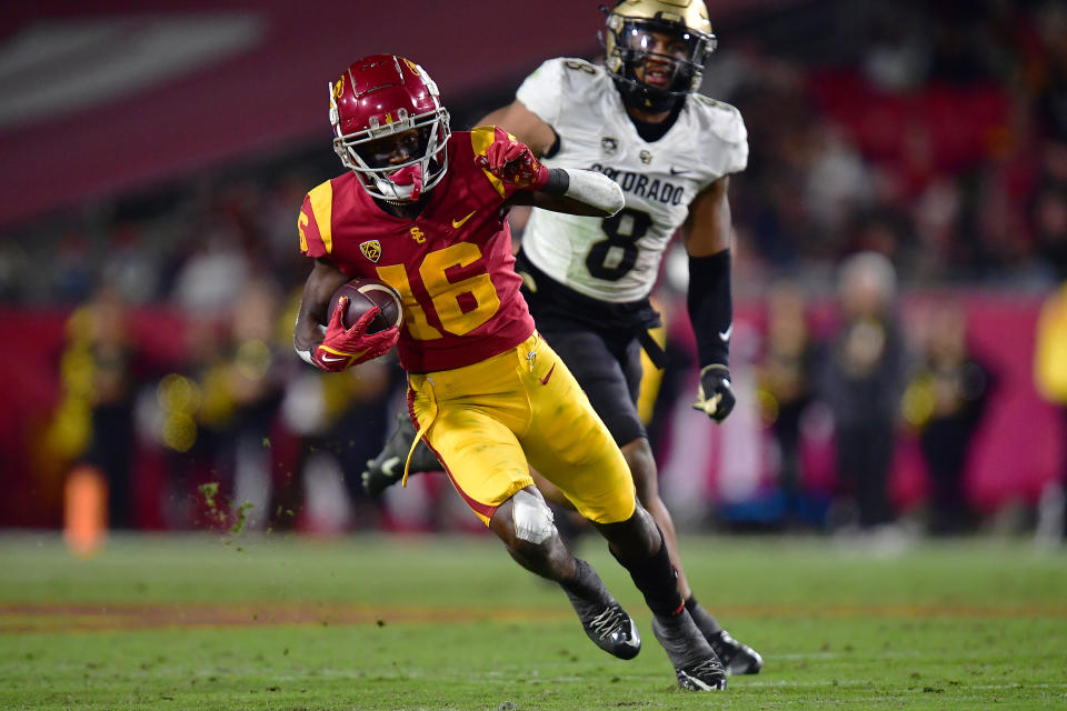 Nov 11, 2022; Los Angeles, California, USA; Southern California Trojans wide receiver Tahj Washington (16) runs the ball ahead of Colorado Buffaloes linebacker Josh Chandler-Semedo (8) during the second half at the Los Angeles Memorial Coliseum. Mandatory Credit: Gary A. Vasquez-USA TODAY Sports