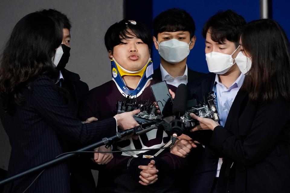 <p>Cho Ju-bin, centre, leader of South Korea’s largest online sexual blackmail ring, pictured outside a police station in March</p> (AP)